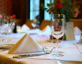 A table set with wine glasses and napkins.