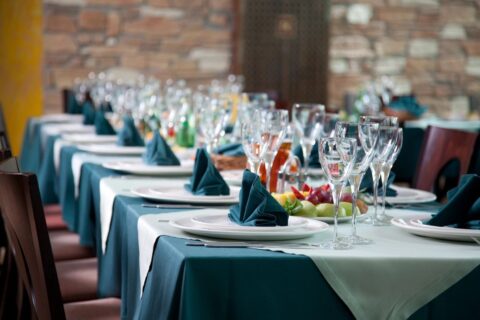 A table set with plates and glasses for a party.