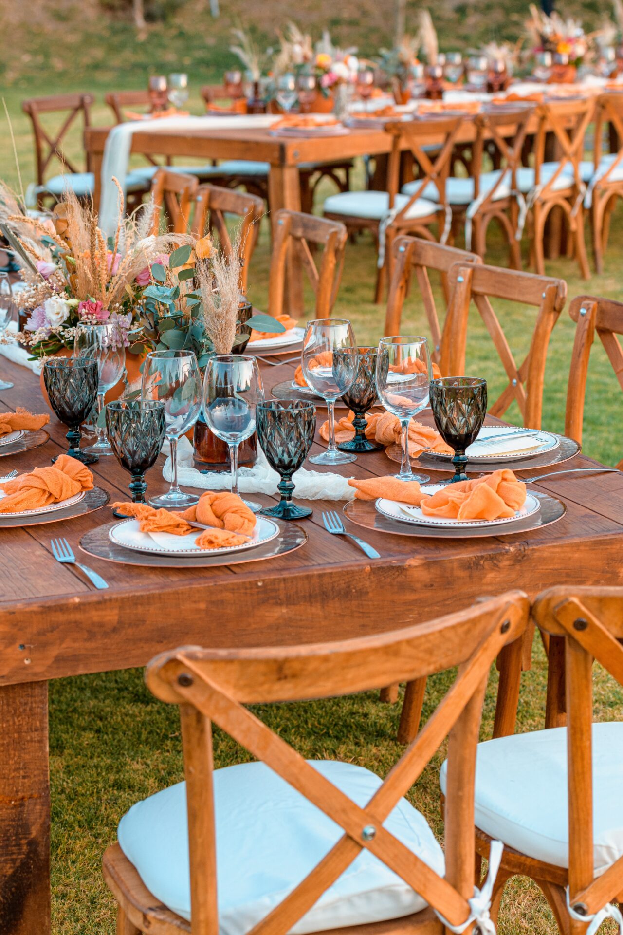 A wooden table with plates and glasses on it